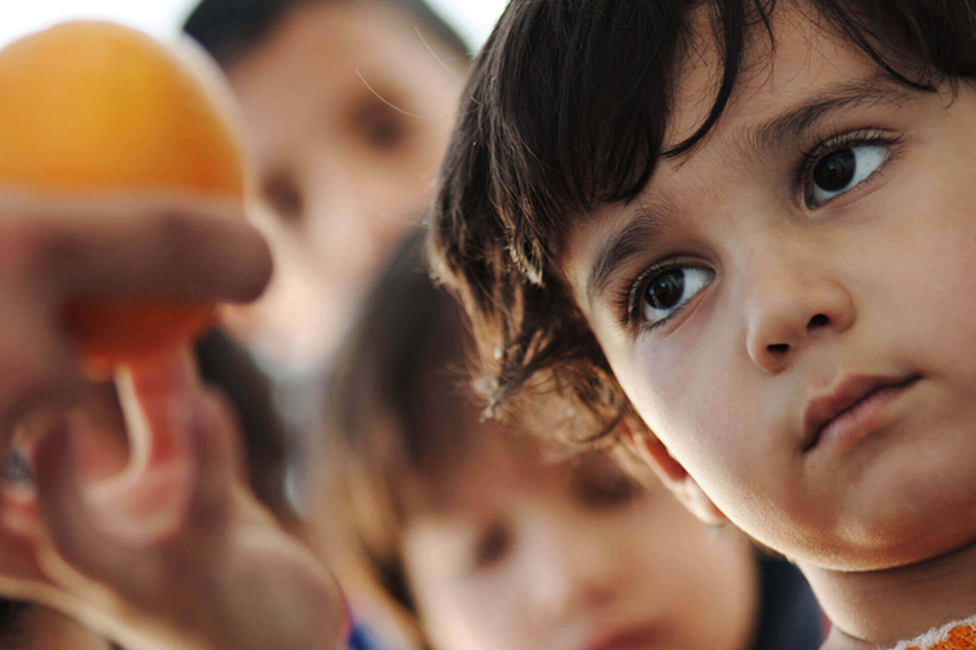 a child being handed a fruit